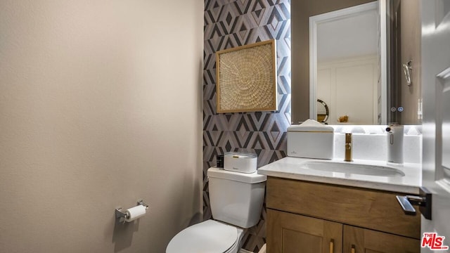 bathroom featuring toilet and vanity