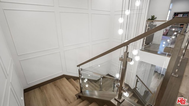 staircase with wood-type flooring