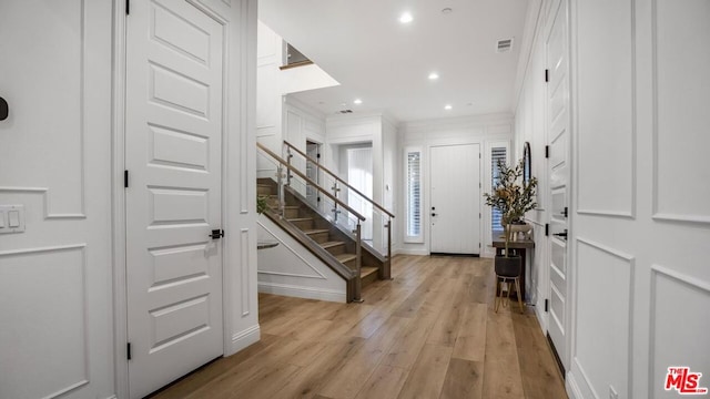 foyer entrance with light hardwood / wood-style flooring