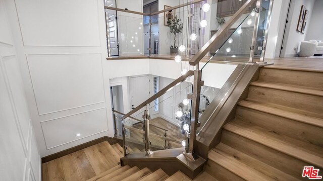 staircase featuring hardwood / wood-style flooring