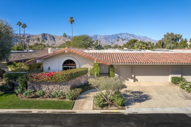 single story home featuring a mountain view and a garage