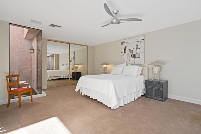 bedroom featuring ceiling fan, a closet, and carpet floors