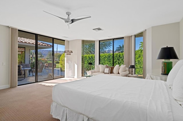 bedroom featuring ceiling fan, access to exterior, carpet, and expansive windows