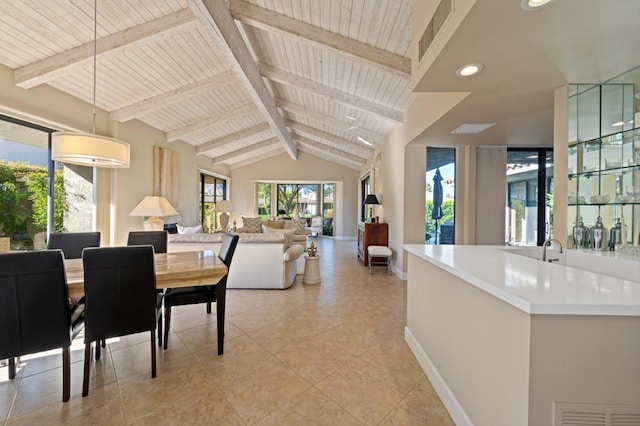 tiled dining space with vaulted ceiling with beams, wood ceiling, and sink