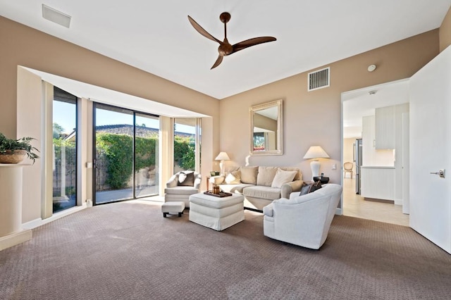 carpeted living room featuring ceiling fan