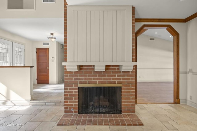 room details featuring a brick fireplace and crown molding