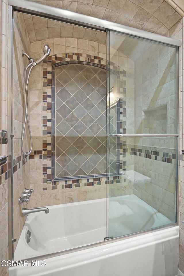 bathroom featuring combined bath / shower with glass door