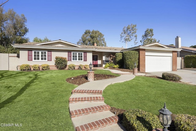 ranch-style house featuring a front yard and a garage