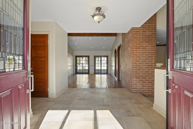 foyer entrance featuring beamed ceiling