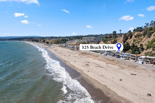 drone / aerial view featuring a water view and a beach view