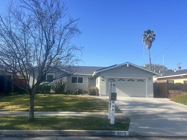 single story home featuring a garage and a front yard