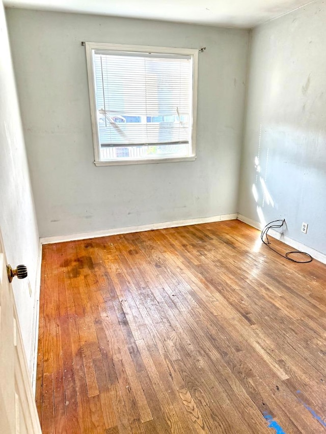 spare room with hardwood / wood-style flooring