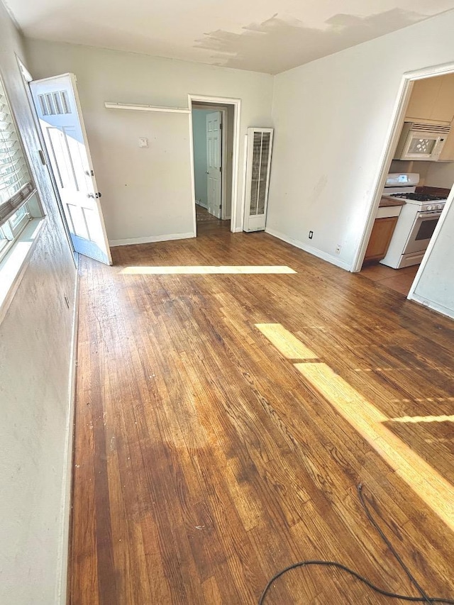 empty room featuring wood-type flooring and basketball hoop