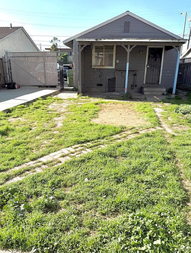 rear view of property with a yard