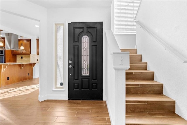 entryway with a wealth of natural light and hardwood / wood-style floors