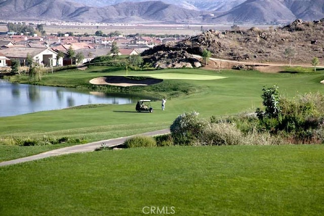 surrounding community featuring a yard and a water and mountain view