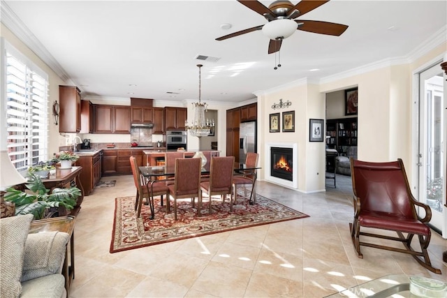 dining room with crown molding, plenty of natural light, and light tile patterned flooring