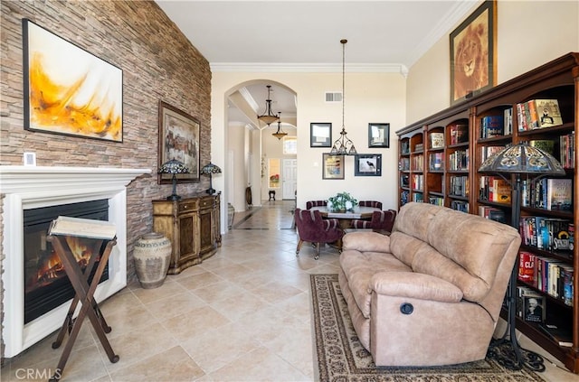 living room featuring light tile patterned floors and crown molding