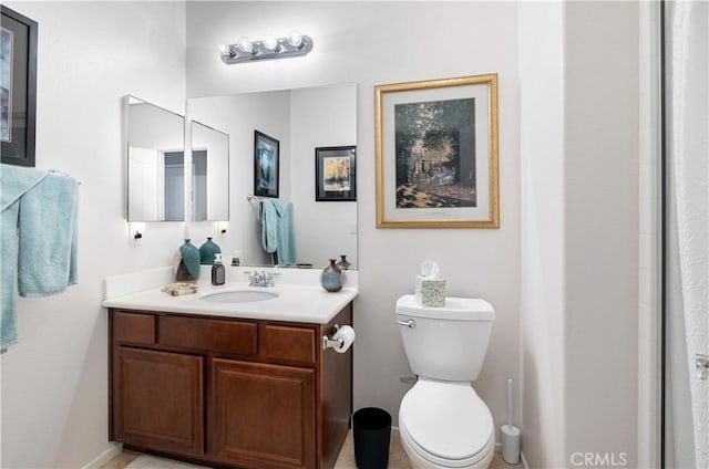 bathroom featuring vanity, an enclosed shower, and toilet