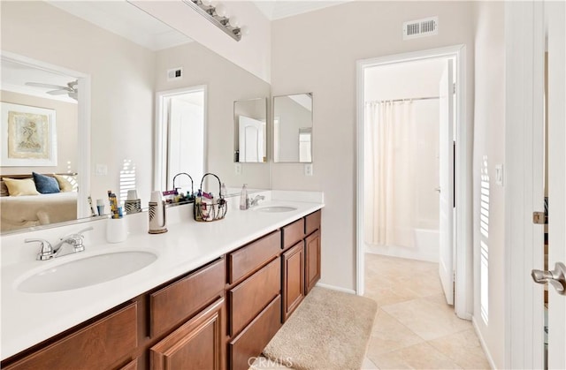 bathroom with ceiling fan, tile patterned floors, shower / bathtub combination with curtain, and vanity