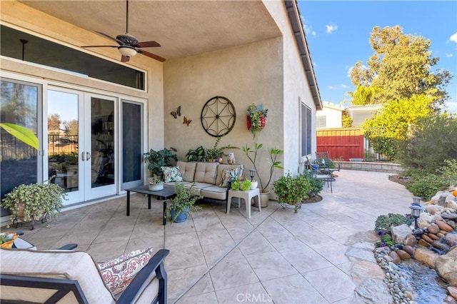 view of patio with an outdoor living space, ceiling fan, and french doors