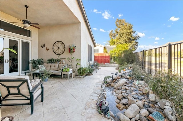 view of patio with an outdoor living space and ceiling fan