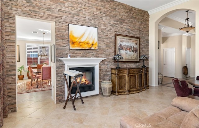 tiled living room with crown molding and a chandelier