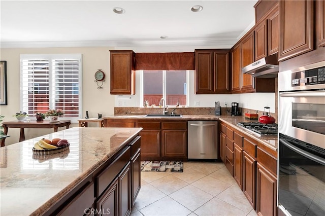 kitchen featuring sink, crown molding, light stone counters, light tile patterned floors, and stainless steel appliances