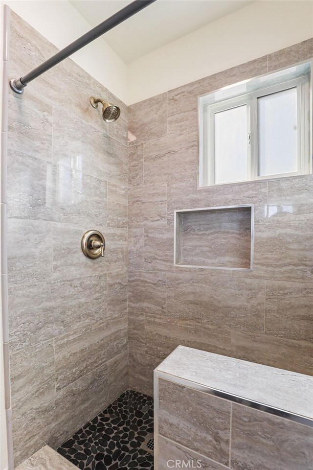 bathroom featuring tiled shower