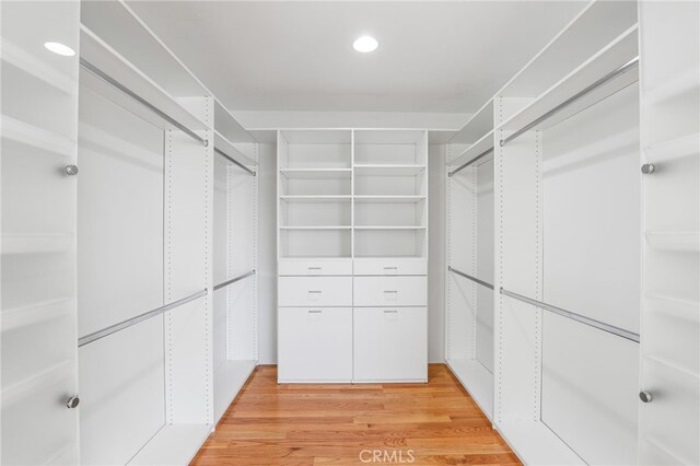 spacious closet with light hardwood / wood-style flooring