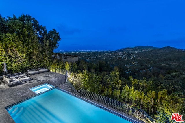 view of swimming pool with a patio area and an in ground hot tub