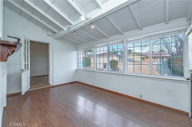 unfurnished sunroom featuring lofted ceiling with beams