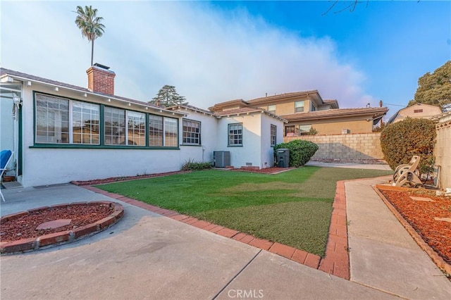 exterior space featuring a lawn and central AC