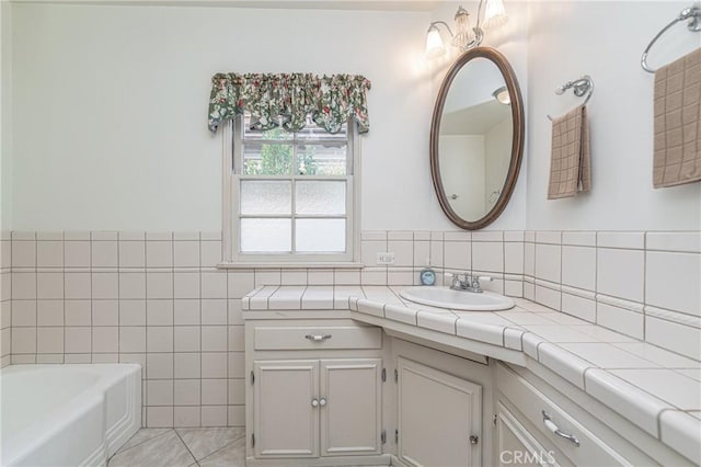 bathroom with a bath, tile walls, tile patterned floors, and vanity