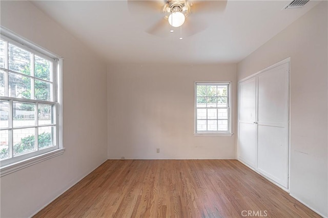 unfurnished room with ceiling fan and light hardwood / wood-style flooring