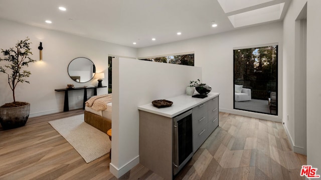 interior space with a skylight and light wood-type flooring