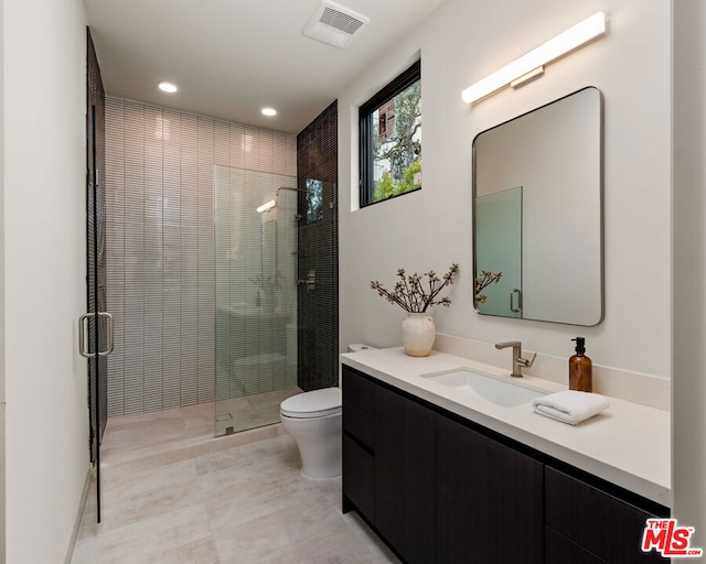 bathroom with toilet, vanity, and an enclosed shower