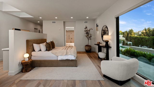 bedroom with light hardwood / wood-style floors