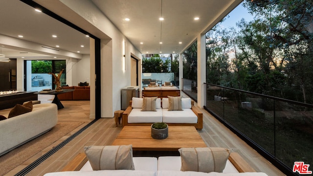 balcony at dusk with an outdoor hangout area