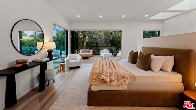 bedroom with a skylight and wood-type flooring