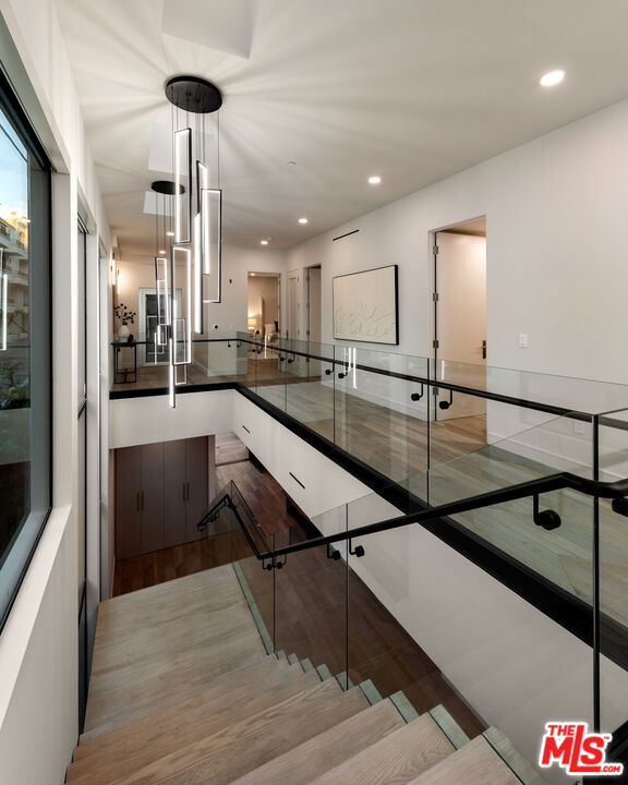 stairs featuring hardwood / wood-style flooring