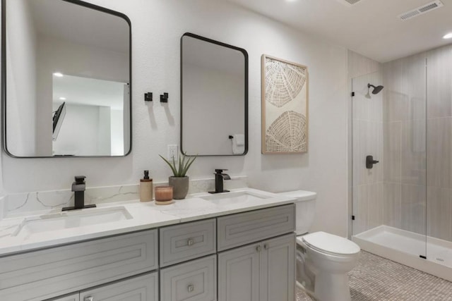 bathroom with vanity, toilet, and a shower with door