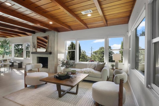 sunroom with beamed ceiling, a premium fireplace, and wooden ceiling