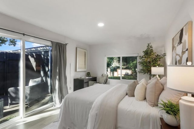 bedroom featuring light wood-type flooring and access to outside