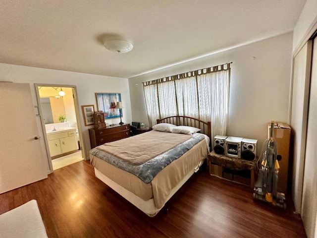 bedroom featuring dark hardwood / wood-style flooring, connected bathroom, and a closet