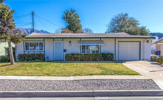 single story home featuring a garage and a front yard