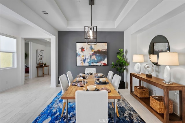 dining space featuring a tray ceiling