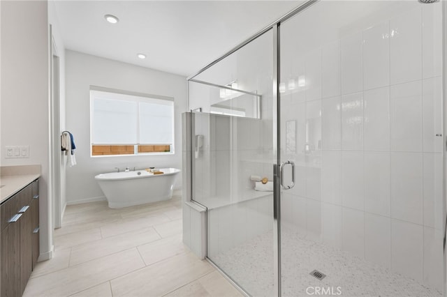 bathroom with tile patterned floors, vanity, and independent shower and bath