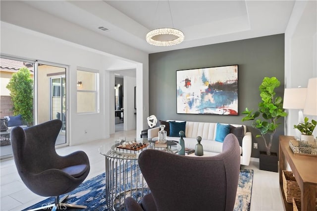 living room featuring a raised ceiling