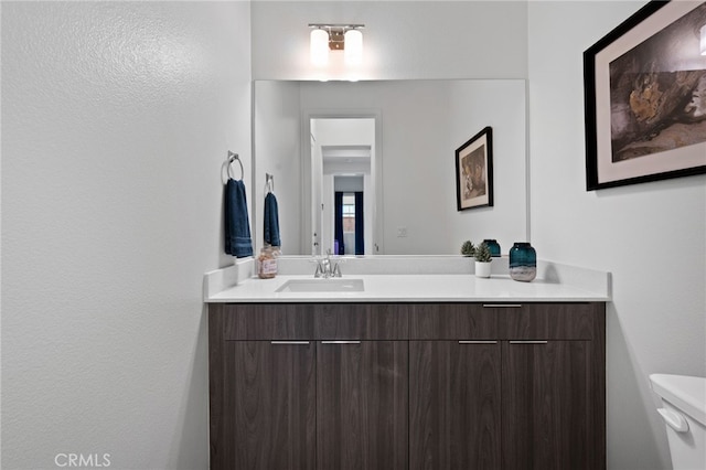 bathroom featuring toilet and vanity